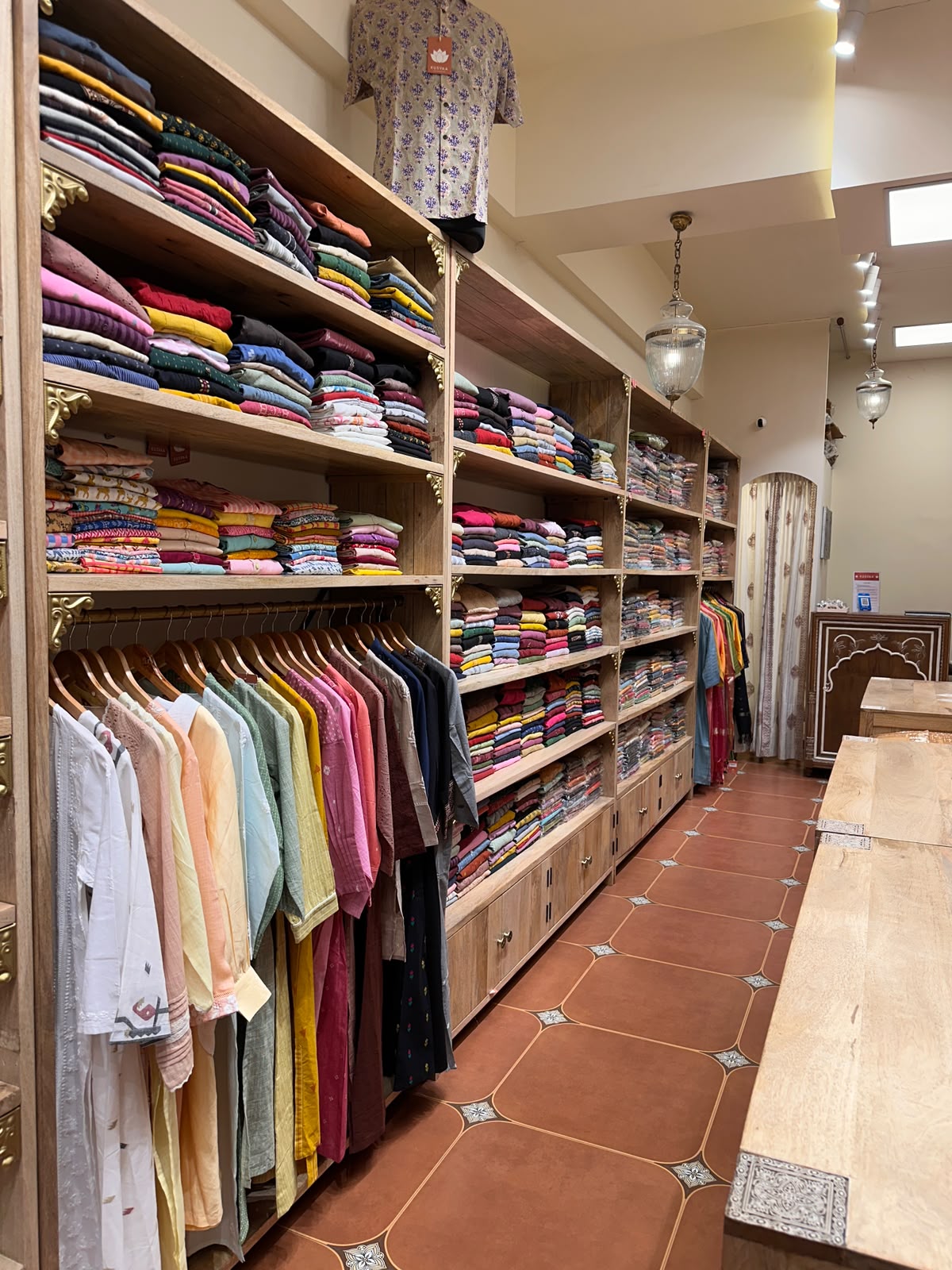 Folded Stacks Hanging Kurtas — inside Kusvaa Vastrapur